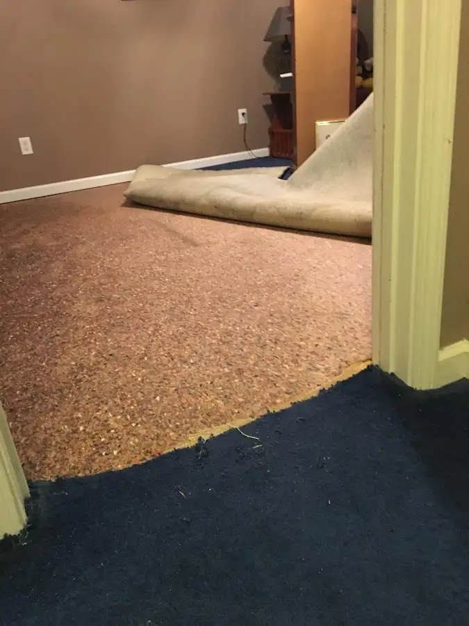 Carpet pad removal revealing water damage during Water Mitigation Services in El Centro